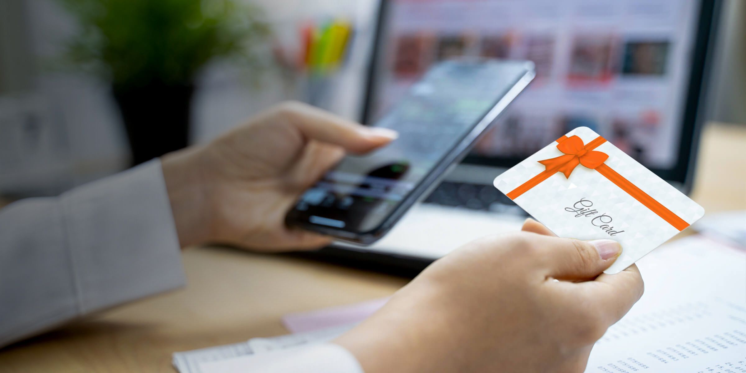 Happy young woman walking on the city street after shopping and using her smartphone