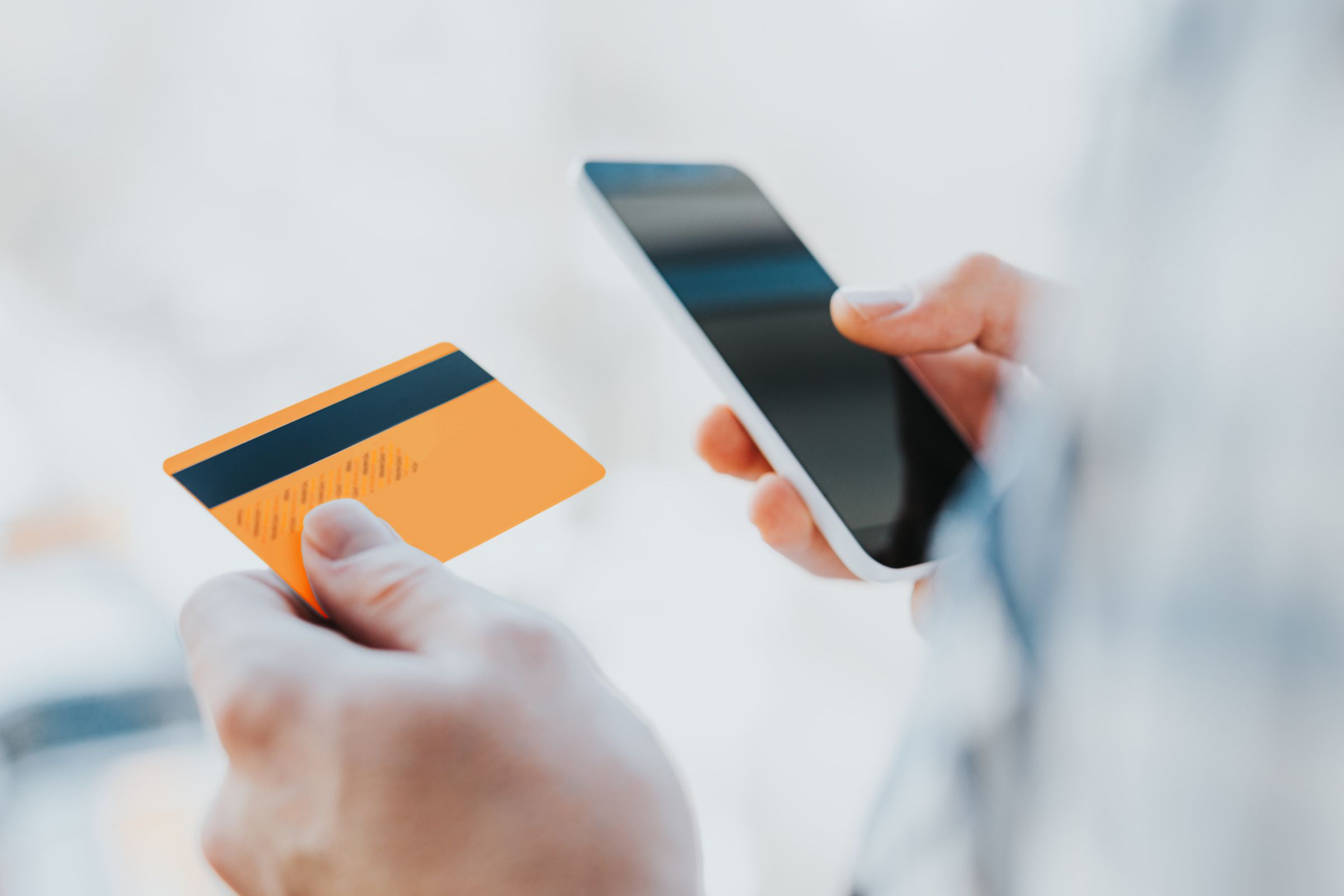 Hands holding phone and card