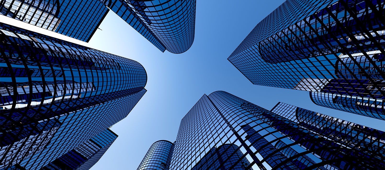 A low-angle view of modern skyscrapers against the sky