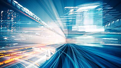 image of city road at night with lights going by