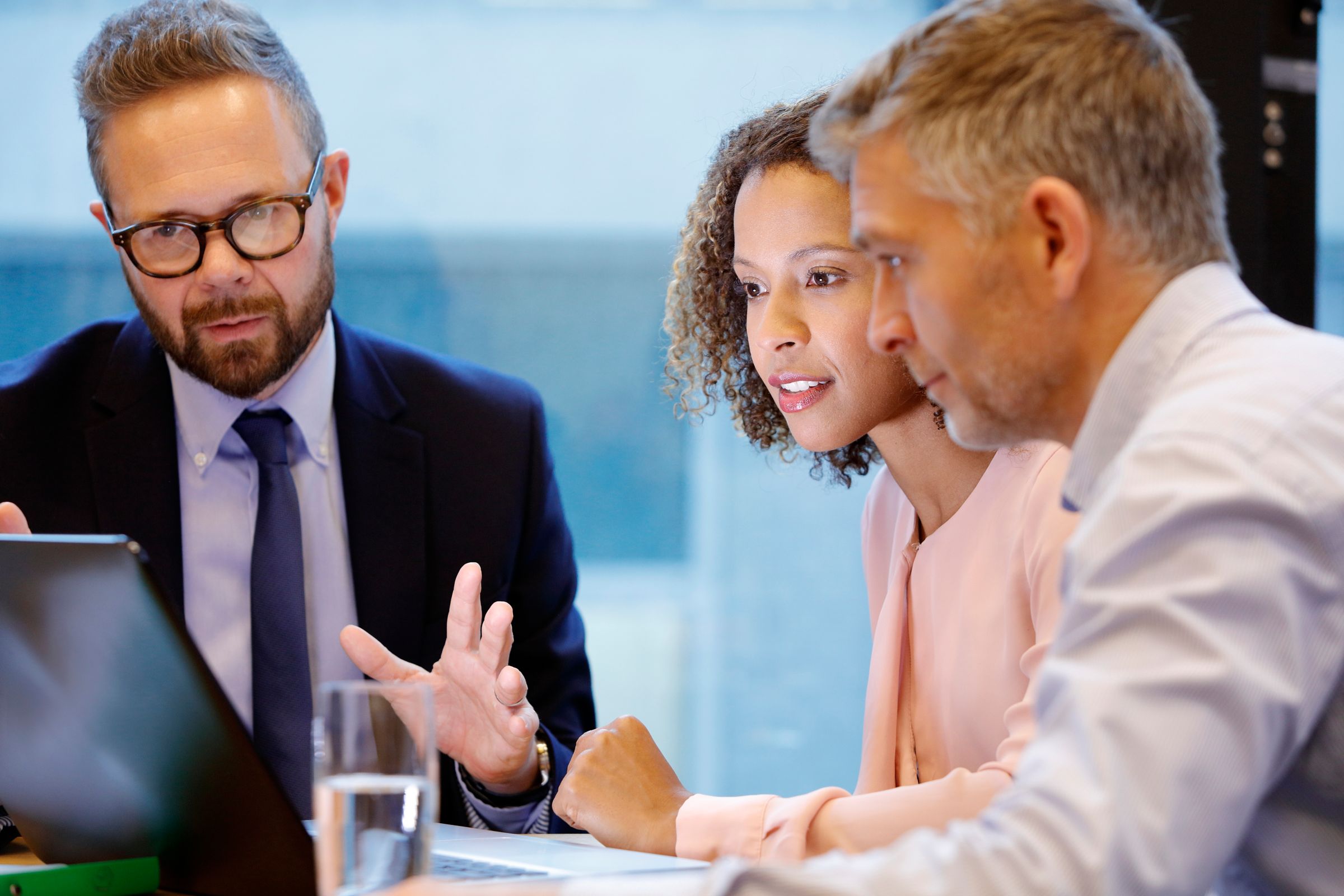 a group of people sitting and discussing at a table