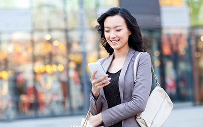 woman smiling looking at phone