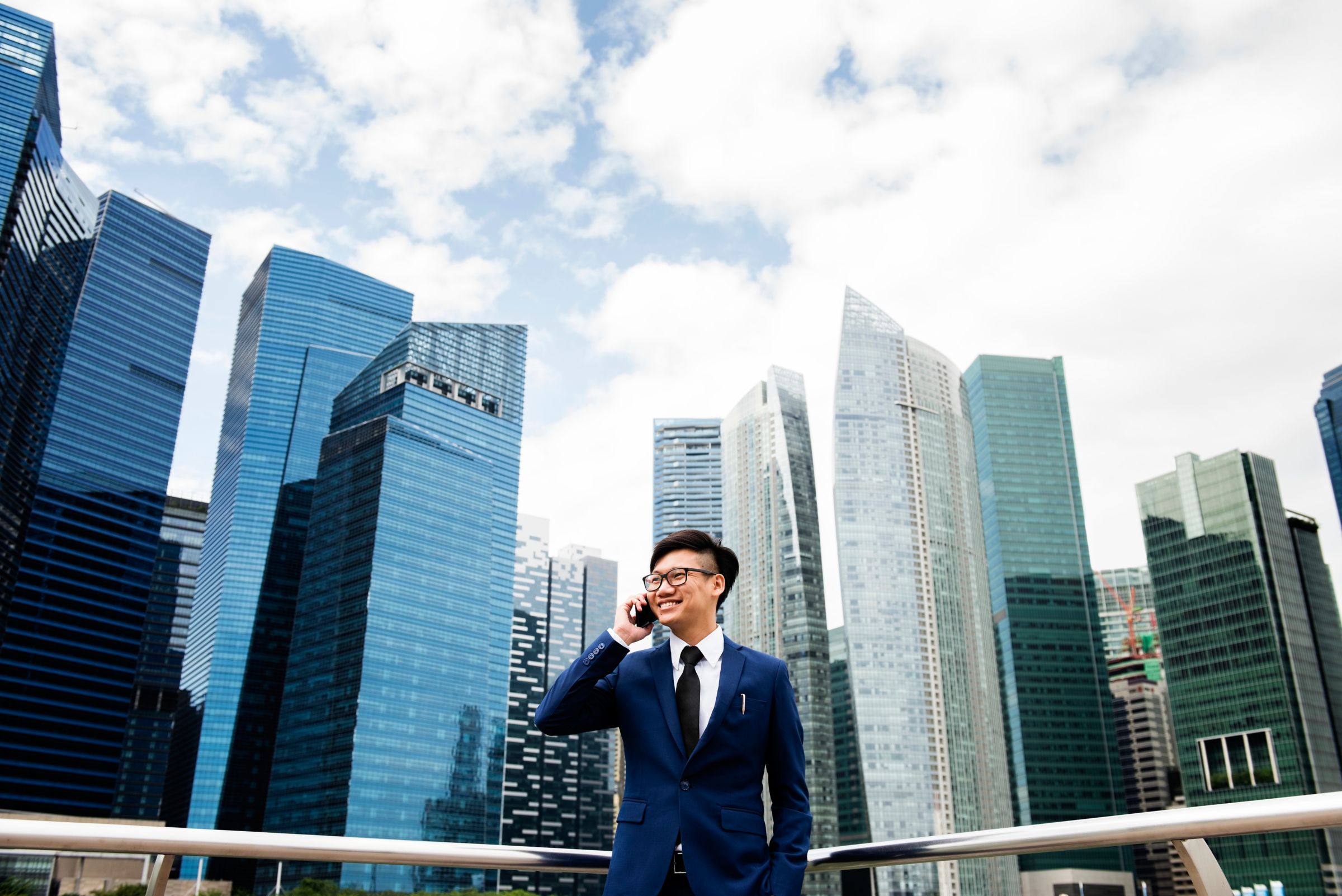 asian man in front of buildings