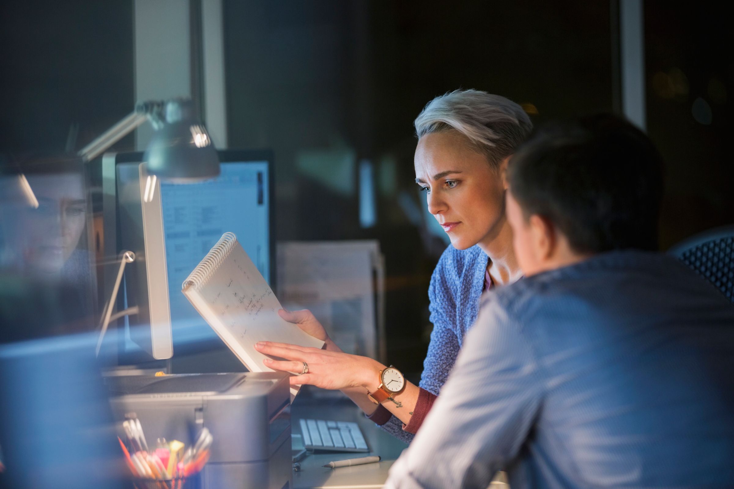 People working together at a desk.