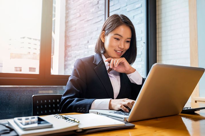 woman at a desk typing on computer