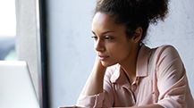 a woman looking at a laptop