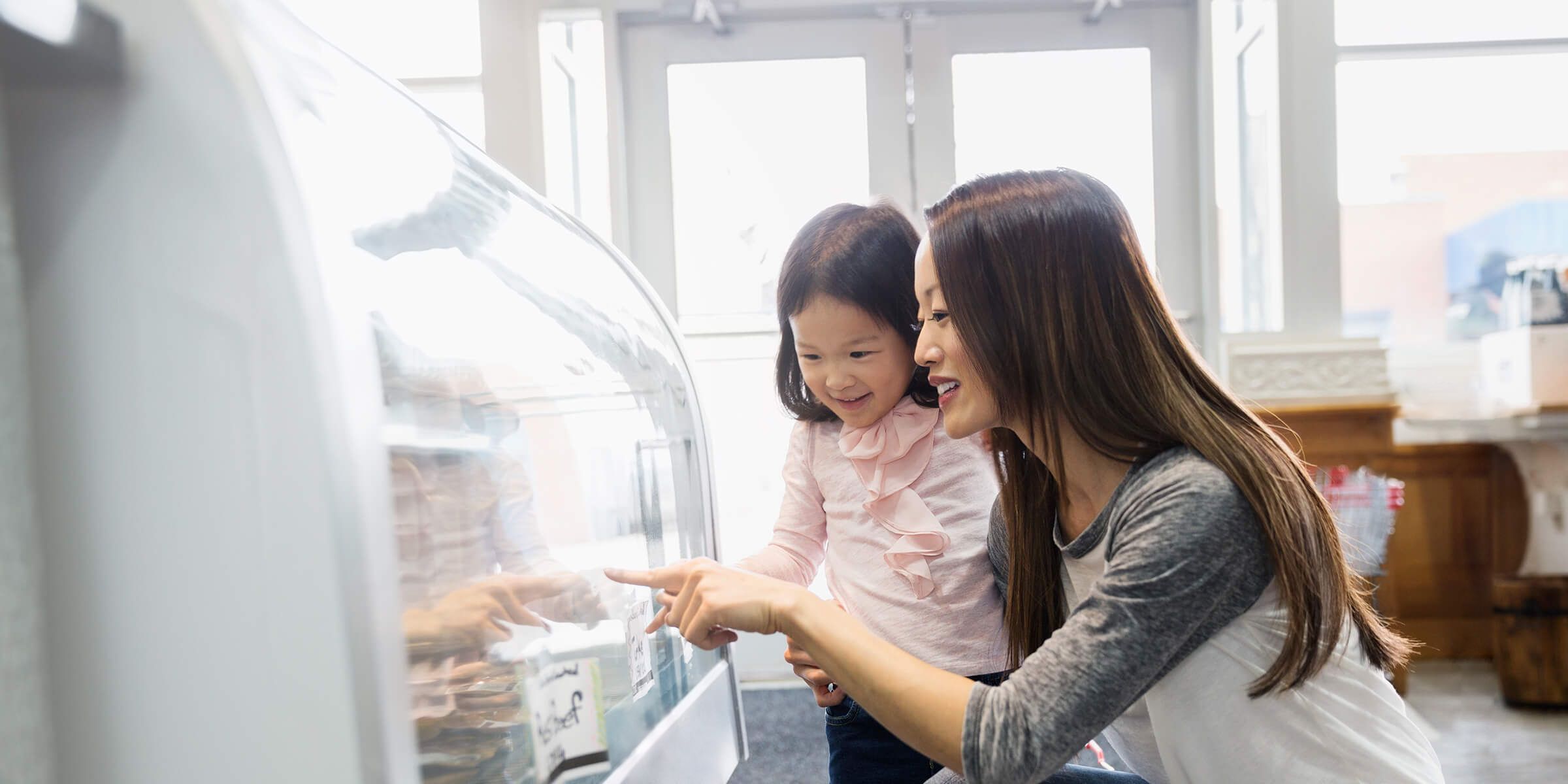 a woman and a child looking at a display