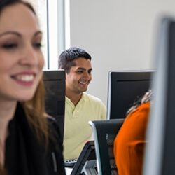 a group of people working on computers