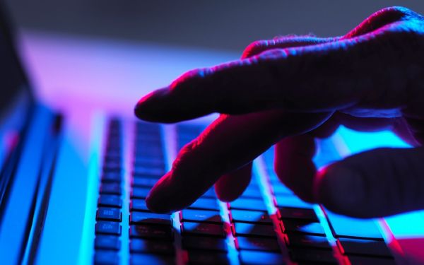 a close up of a hand typing on a keyboard