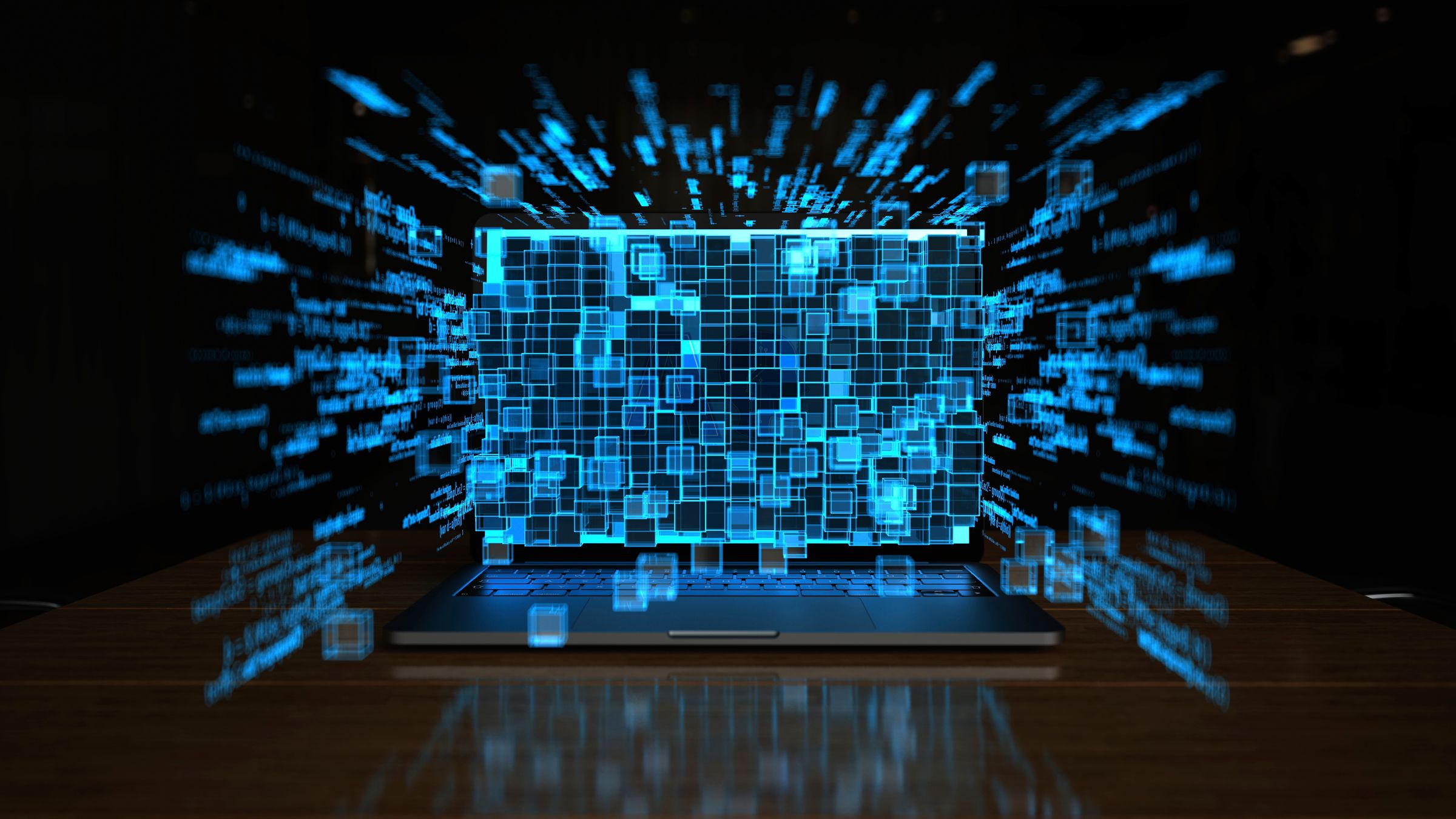 Hands hold mobile phone at a computer