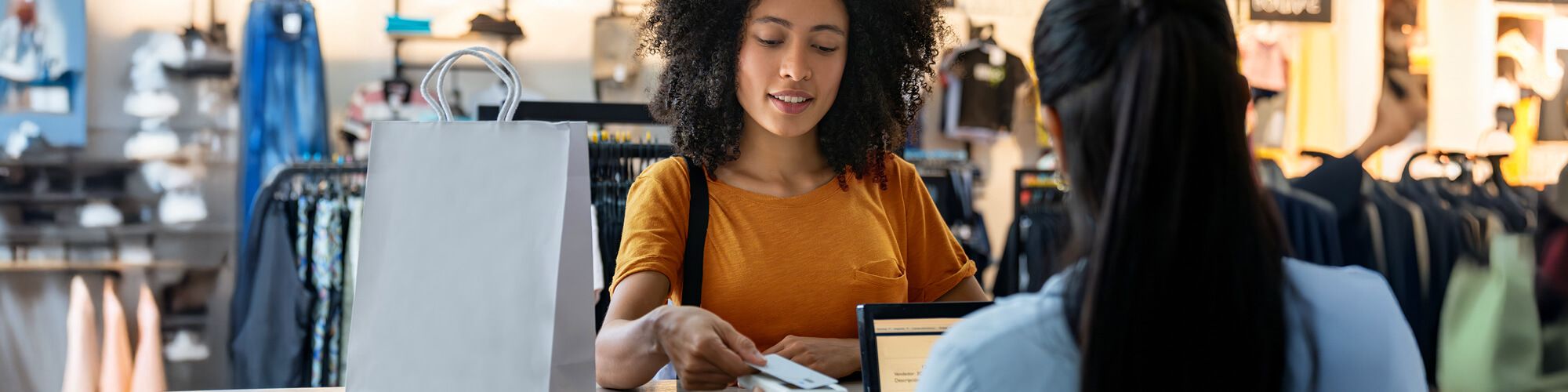 woman using contactless payment at a retail shop