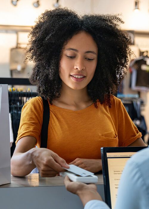 woman using contactless payment at a retail shop