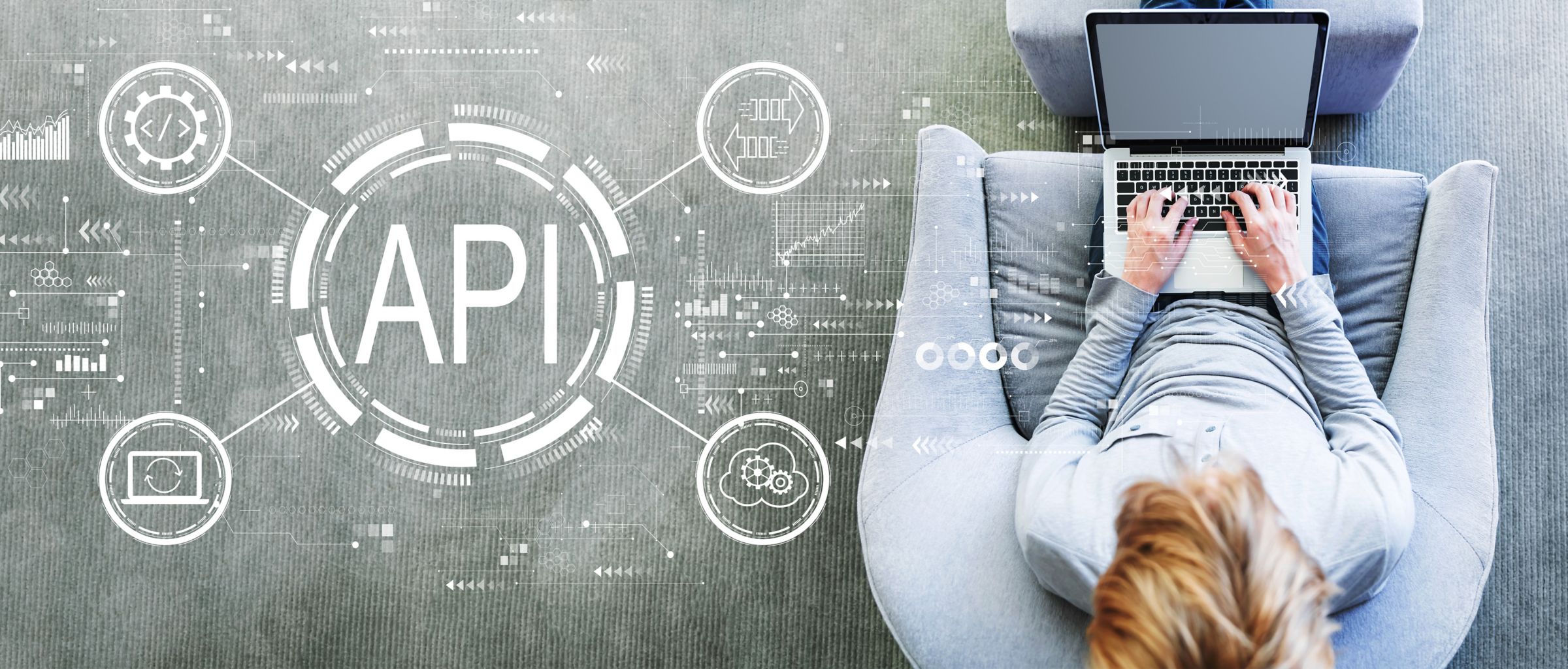 Man sitting typing on laptop with API graphic overlay