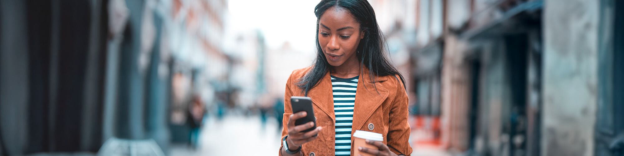 Woman banking by mobile device