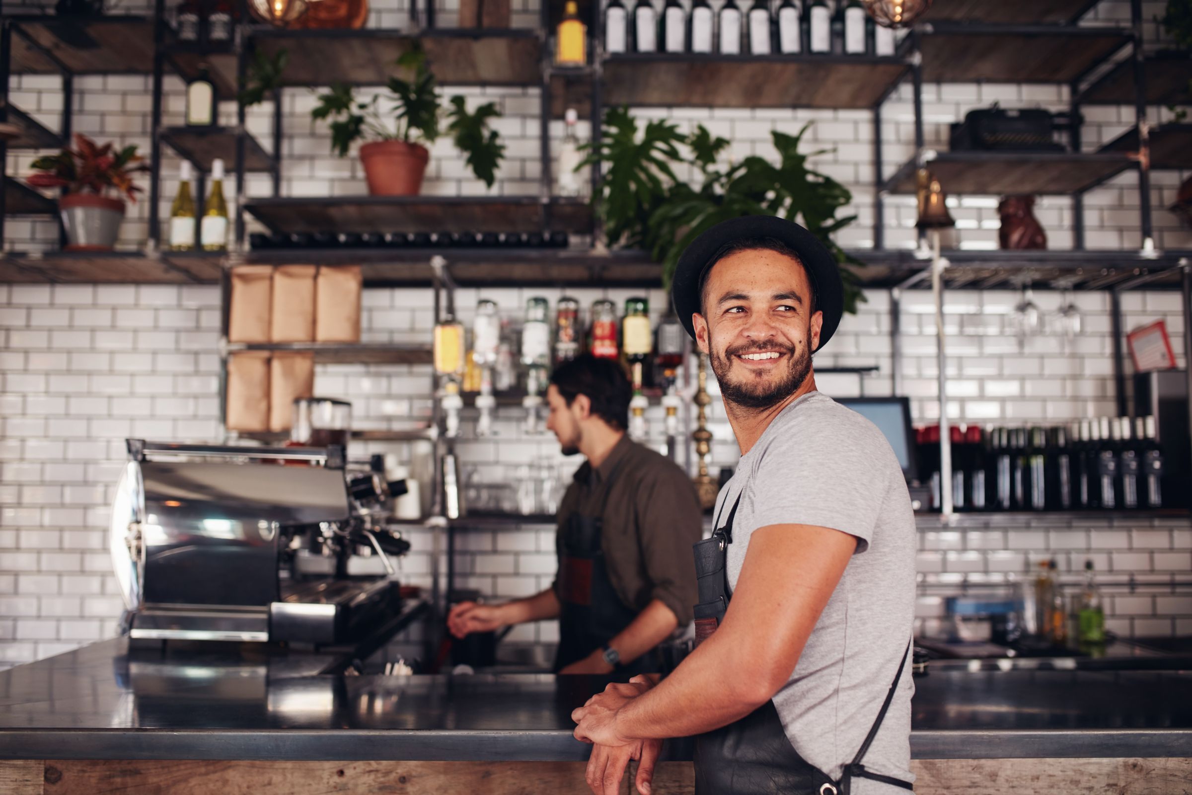 man at a counter wearing an apron