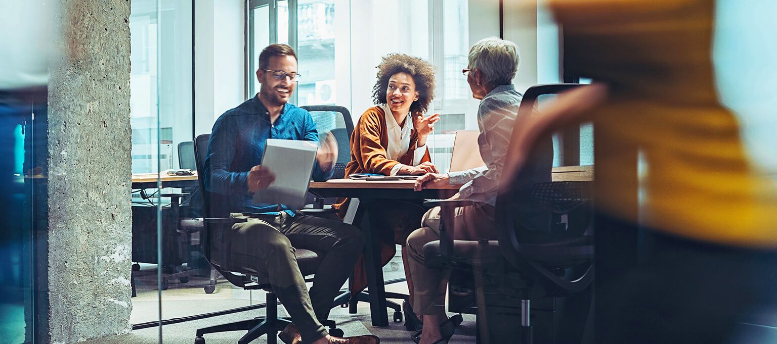 Diverse group of business people smiling and talking