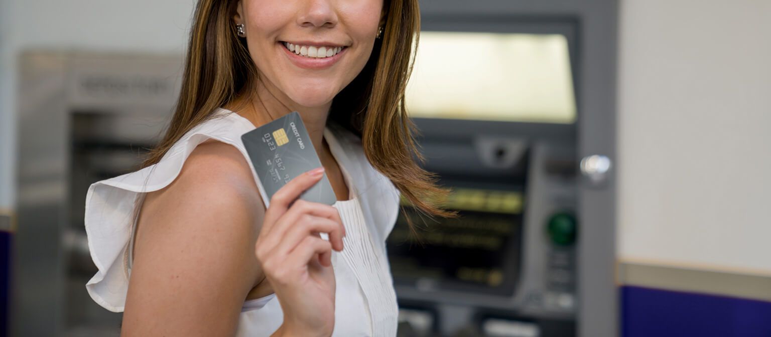 Smiling woman using ATM