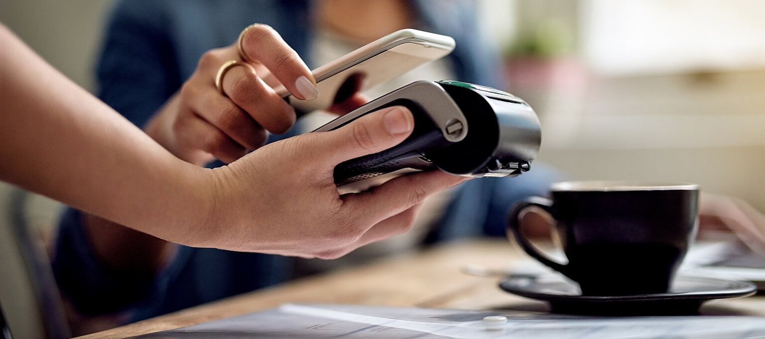 Woman using contactless payment with mobile phone