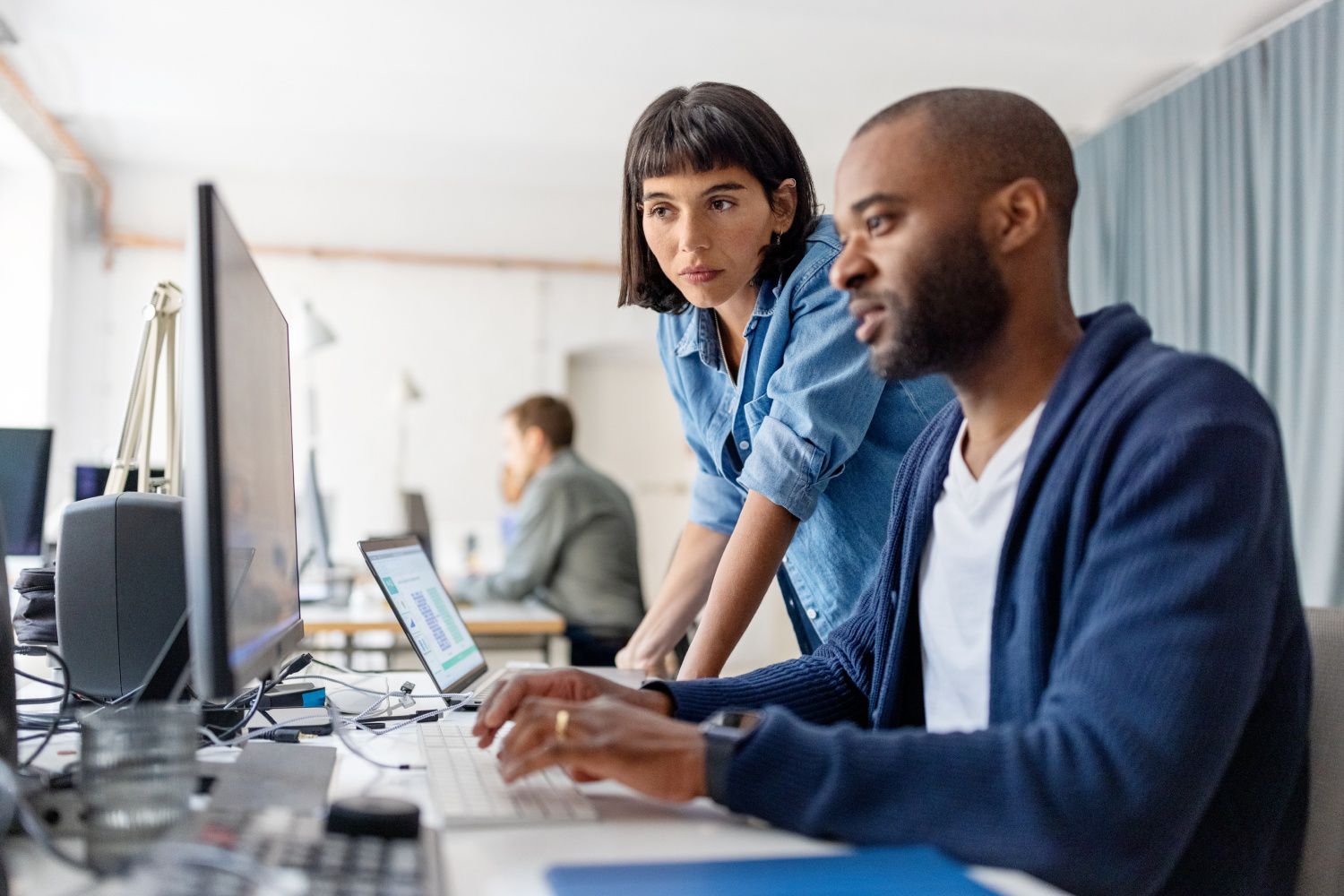 people looking at a computer in an office