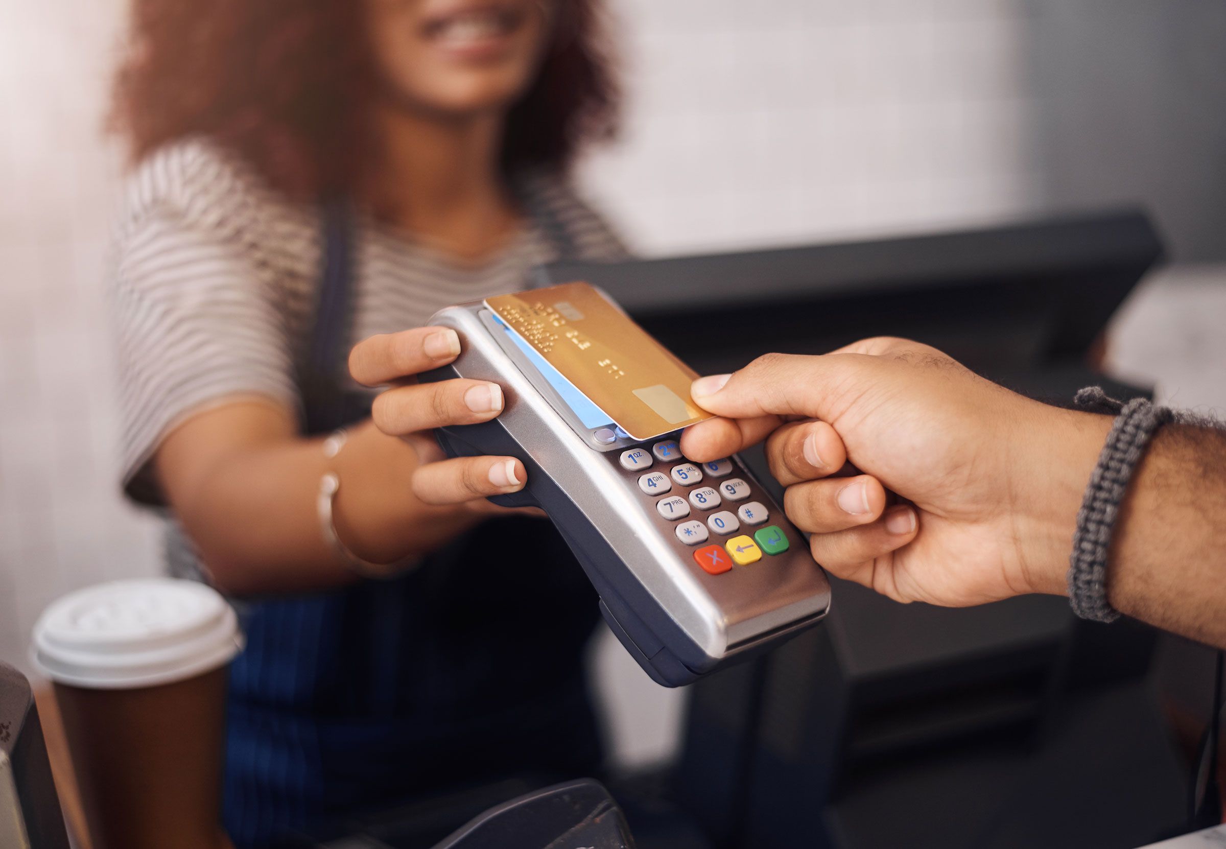 Woman holding credit card using mobile phone