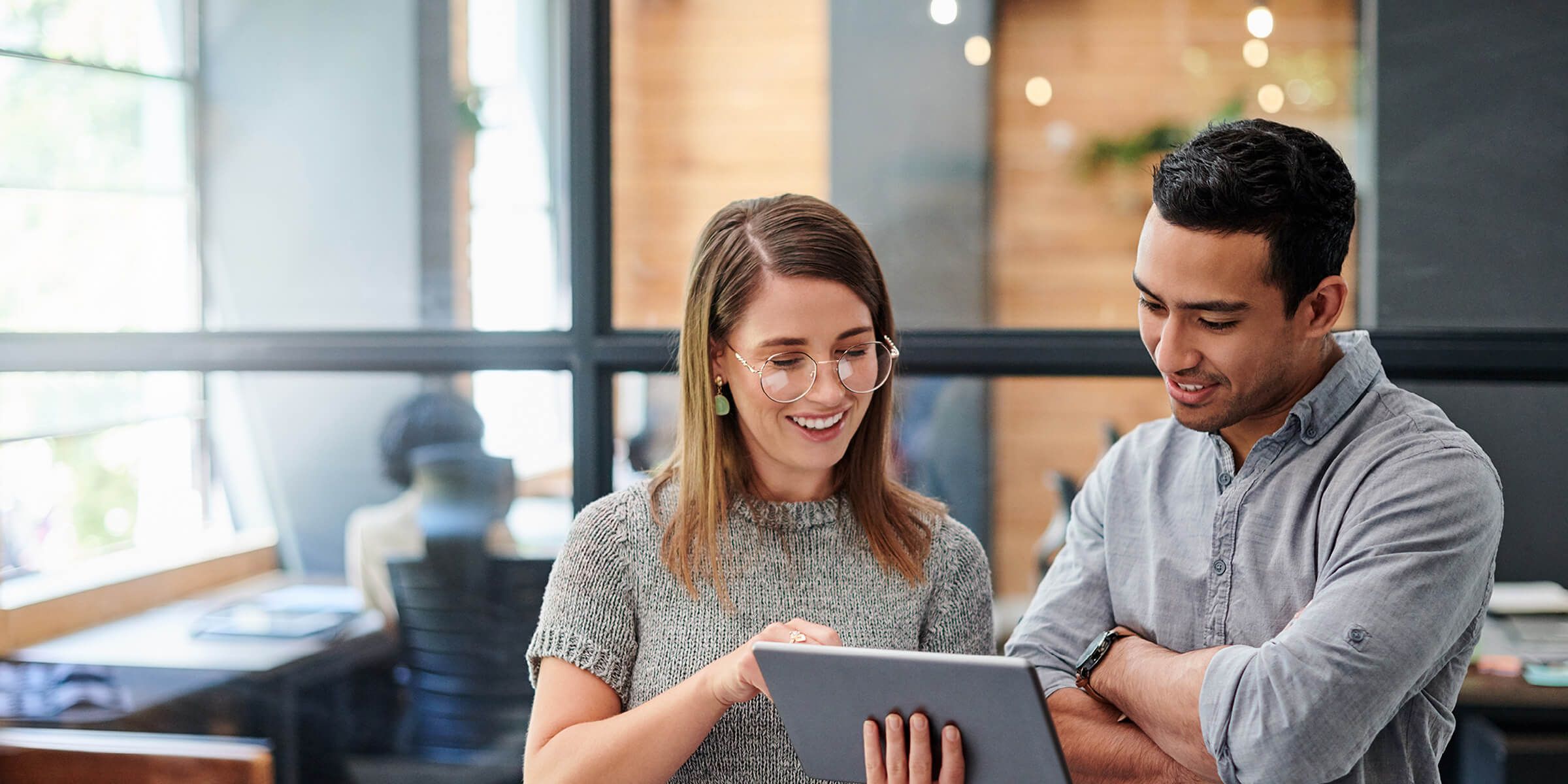 Man and woman smiling looking at iPad
