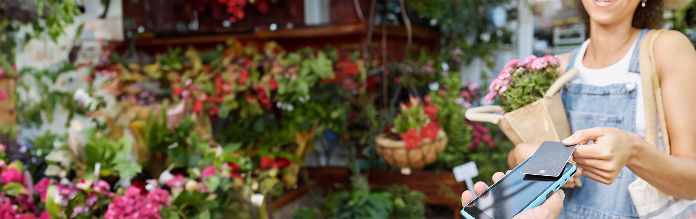 woman buying flowers from shop