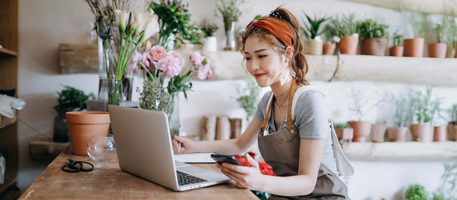 A florist working on her laptop computer.