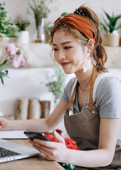 A florist working on her laptop computer.