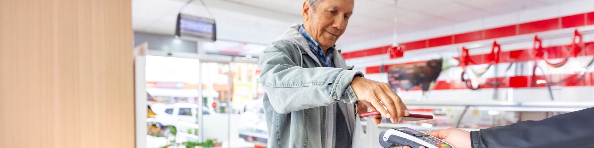 man using phone to pay in store