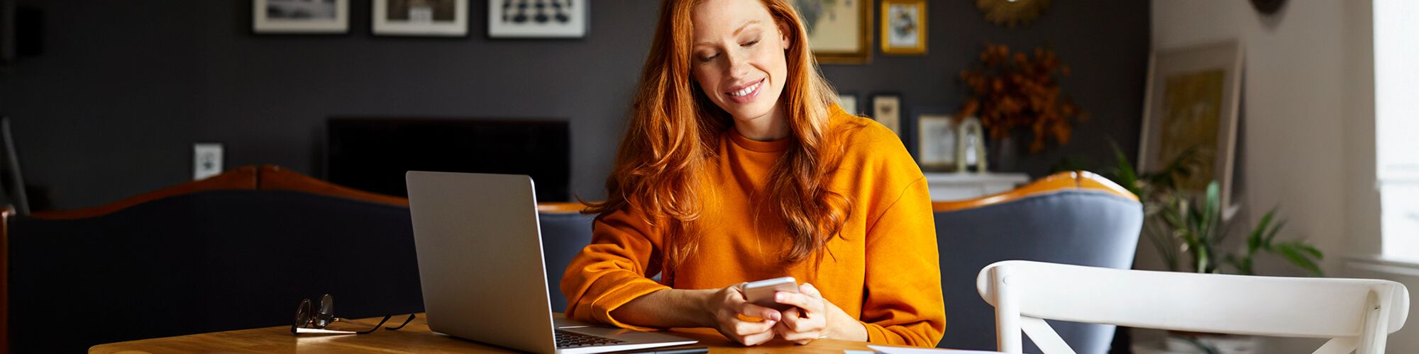 a woman working on her phone and laptop