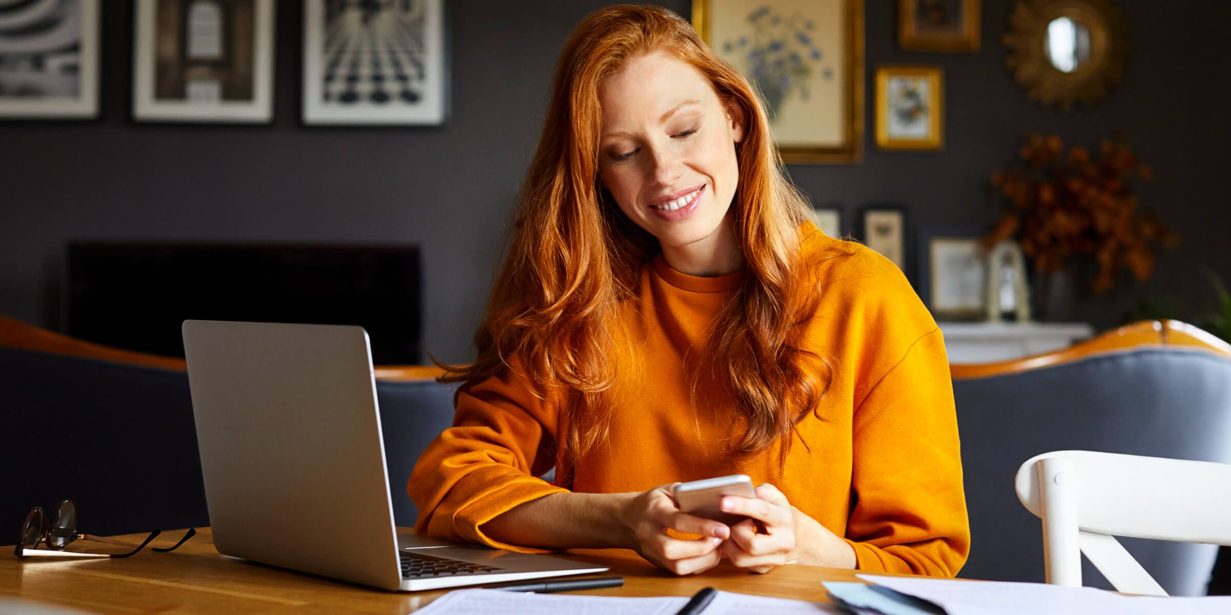 a woman working on her phone and laptop