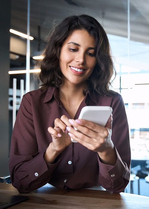 Young Indian business woman manager ceo using cell phone
