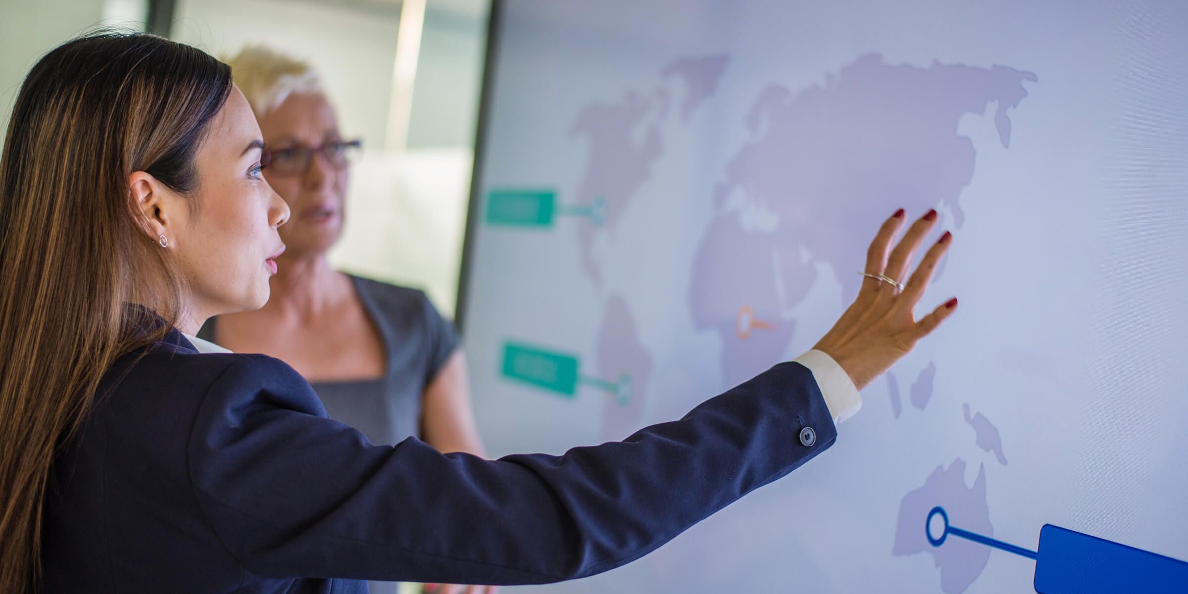 business women looking at chart on screen