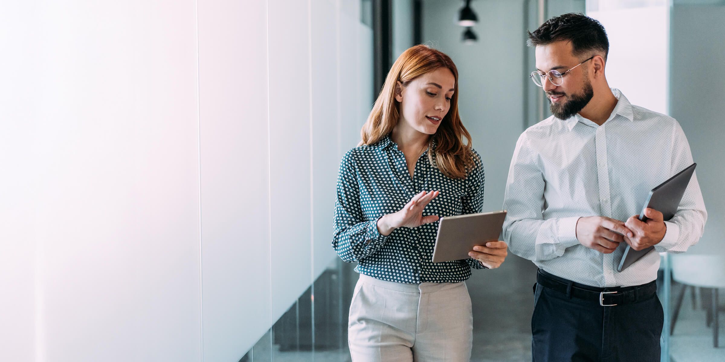 two office workers walking and talking