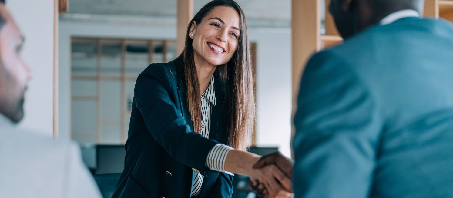 a businesswoman and businessman shaking hands