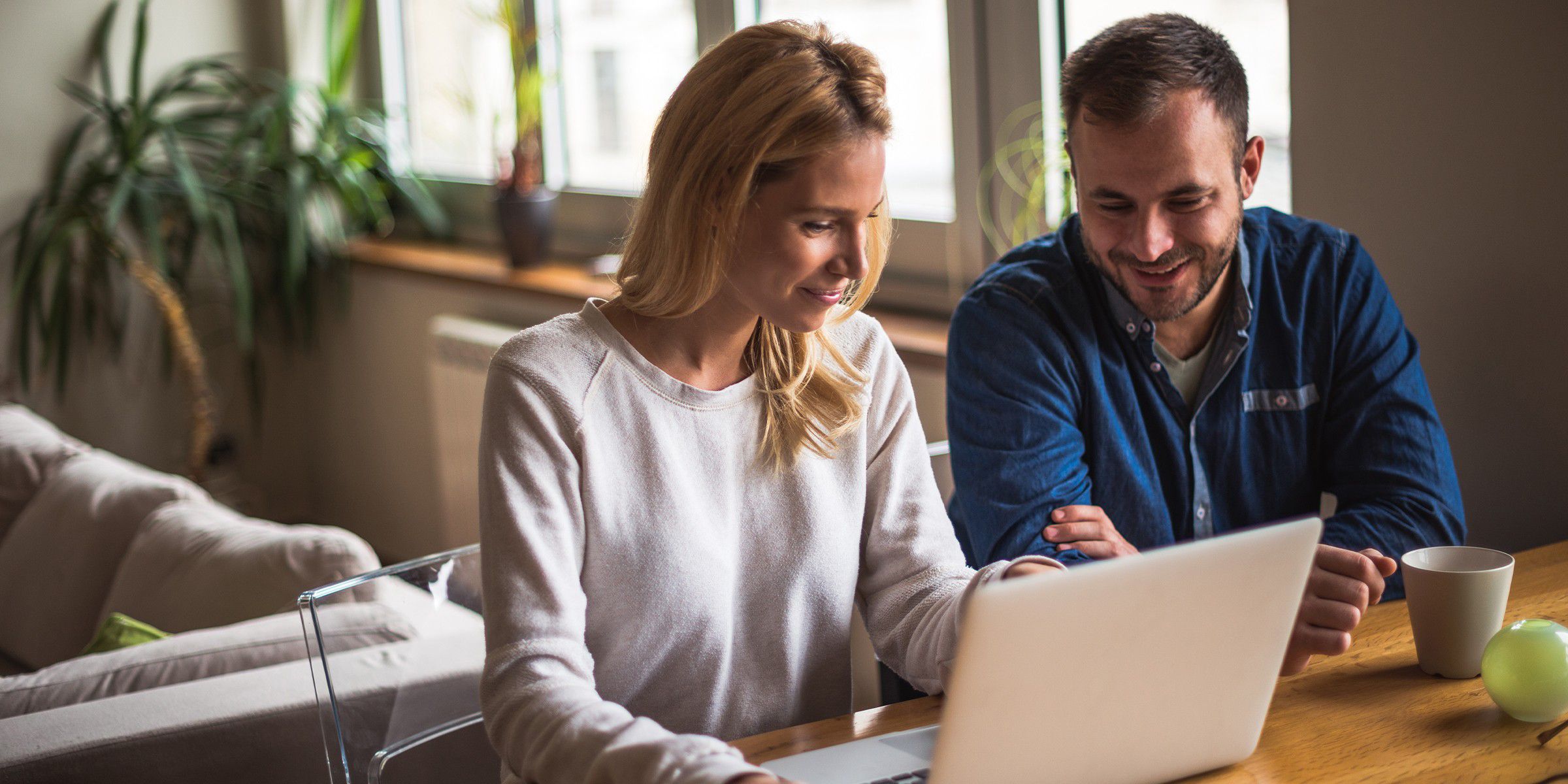 man and woman looking at a laptop