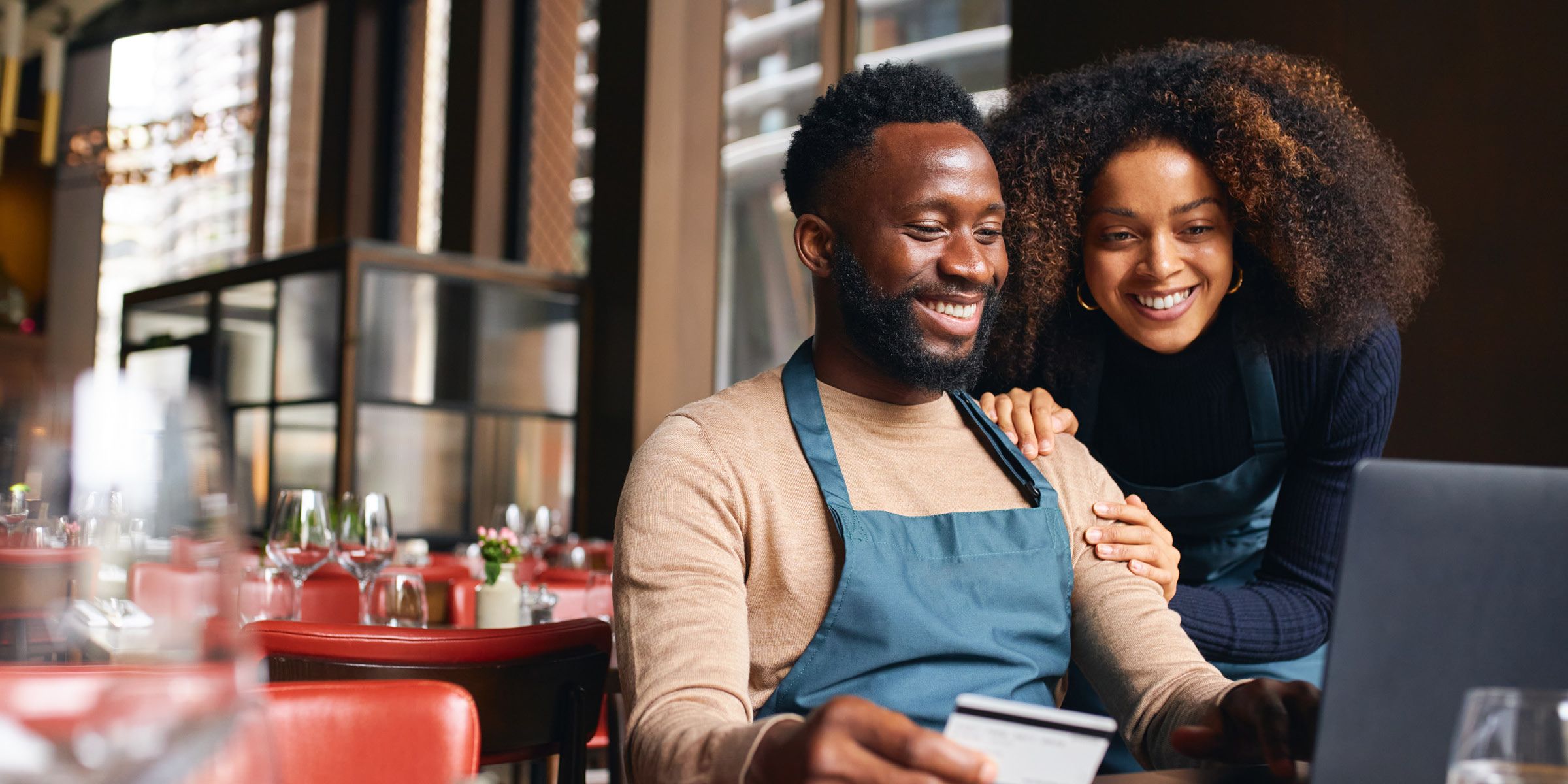 shop owners looking at laptop