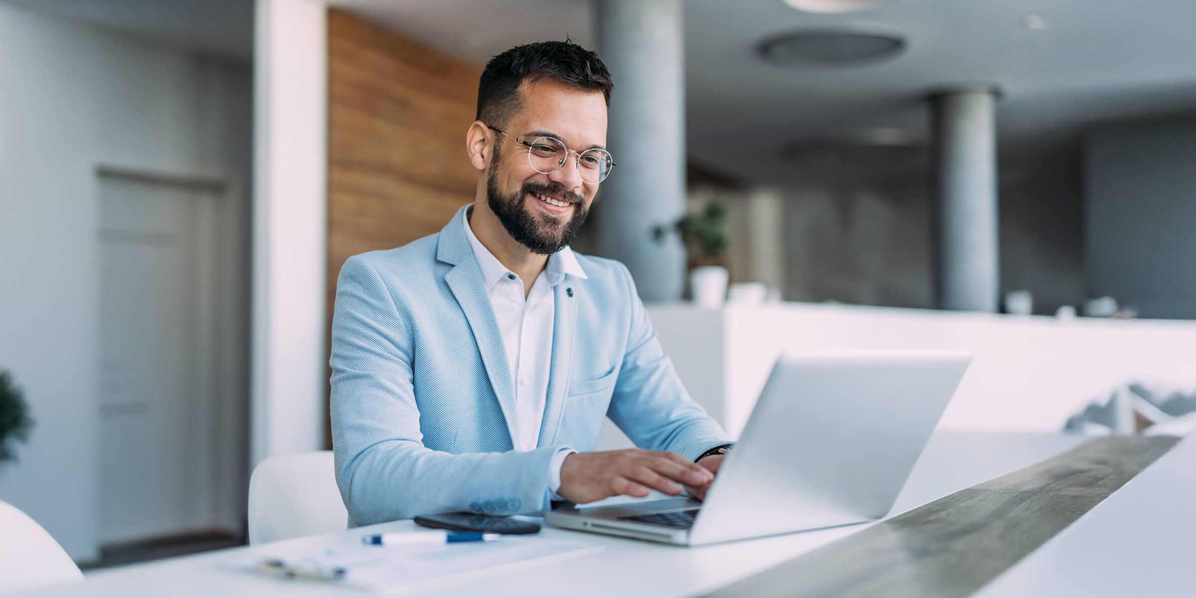 man smiling using laptop