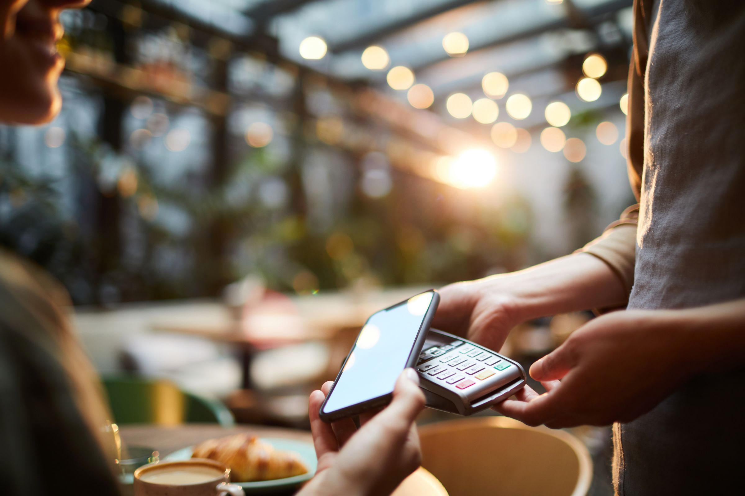 Customer using smartphone for online payment.