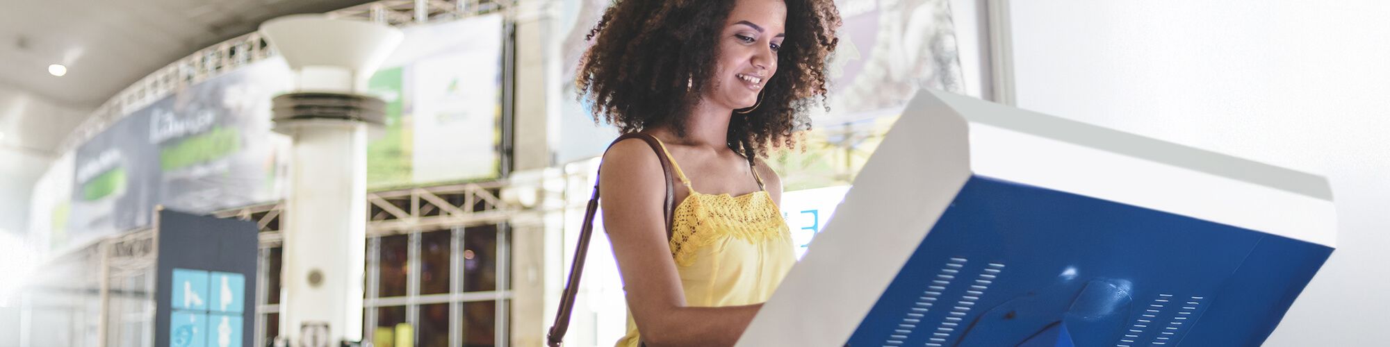 Girl using bank kiosk