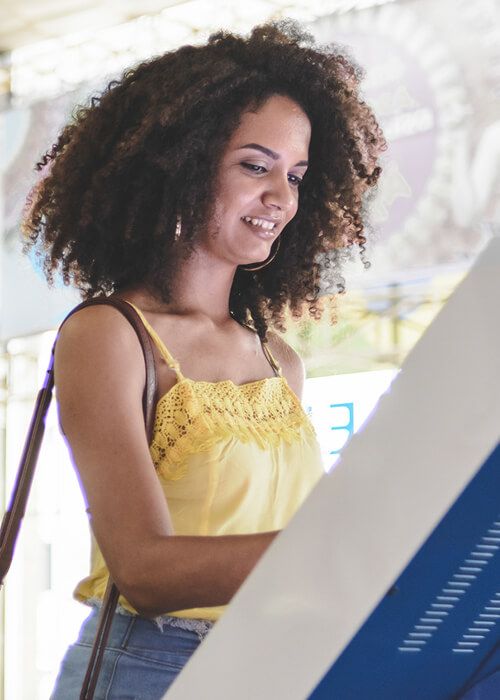 Girl using bank kiosk