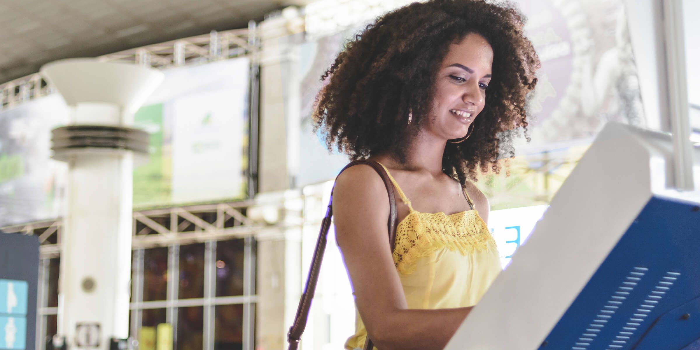 woman standing at self-service kiosk