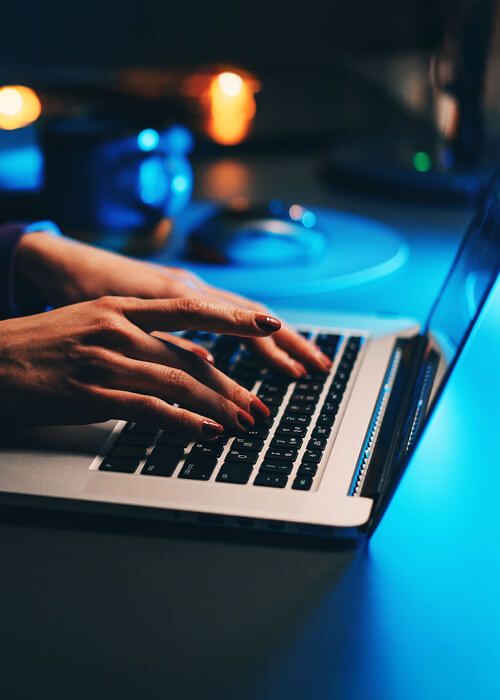 woman typing on a laptop