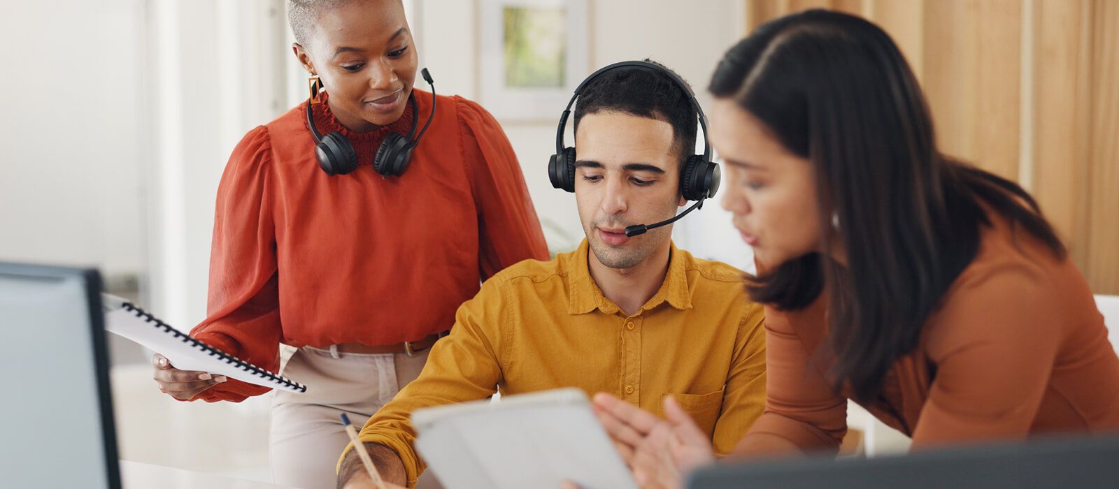 customer service representatives with headsets talking together