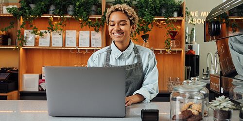 Shop owner in front of computer