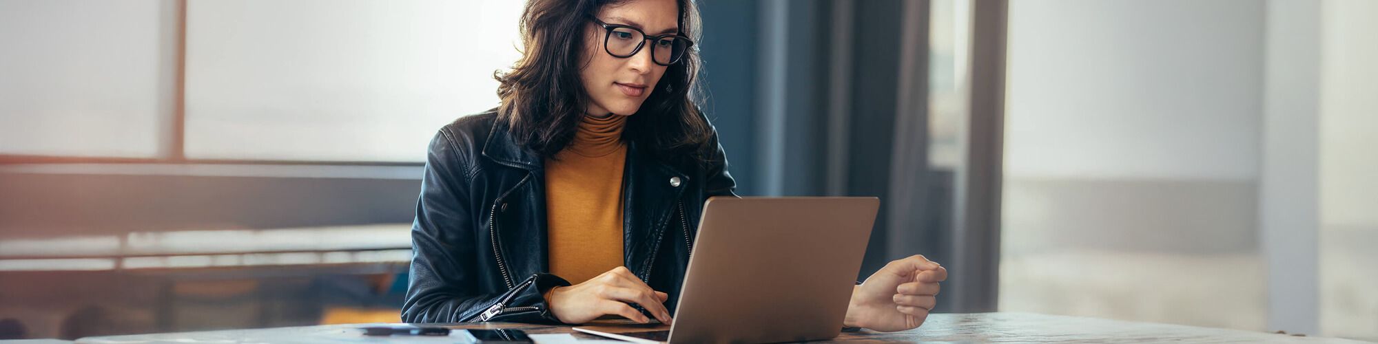 women sitting at laptop working