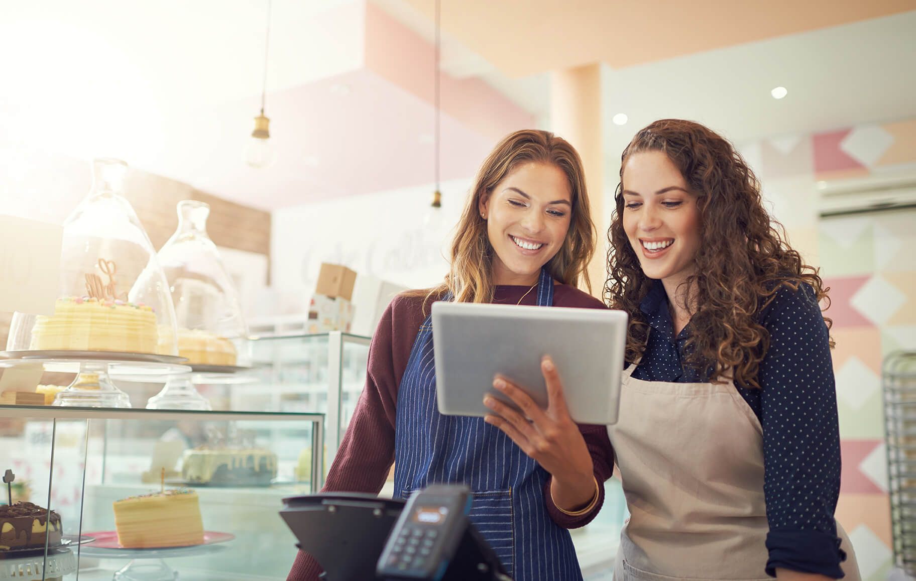 Two small business women looking at a tablet