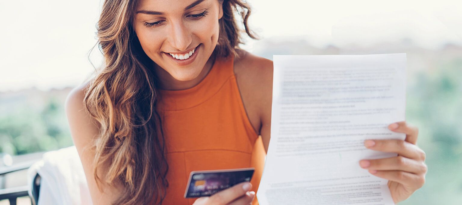 woman looking at a credit card document