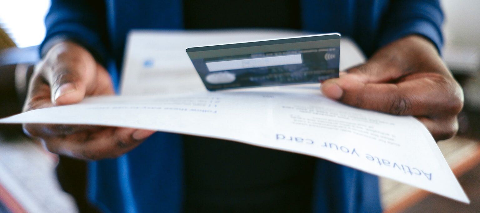 person looking at credit card document