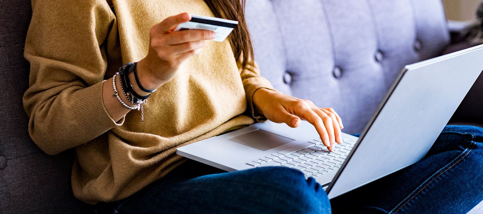 Woman with card and laptop